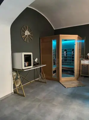a room with a tv and a clock on the wall at Offspa privátní wellness in Prague