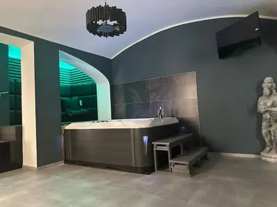 a large bathroom with a tub and a television at Offspa privátní wellness in Prague