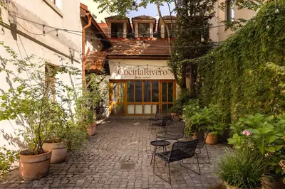 a patio with chairs in front of a building at Delightful Old Town Studio in Prague