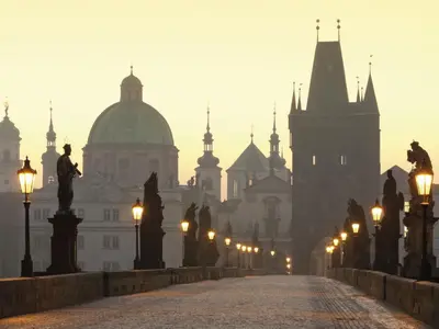 a foggy city with lights and buildings in the background at Apartment Golden Stage Nook by Interhome in Prague