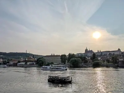 a boat on a river with a city in the background at Apartment Golden Stage Nook by Interhome in Prague