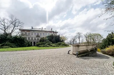 a stone road with a bench in front of a building at Blueground Prague 10 equipped VŠFS University PRG-28 in Prague