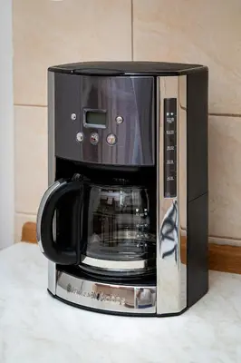 a black microwave oven sitting on top of a counter at Victory Deluxe Suite in Prague