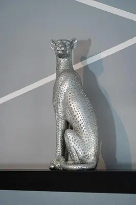 a silver snake vase sitting on a shelf at Penthouse Tiger Deluxe in Prague