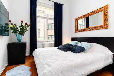 a bedroom with a bed with a mirror on the wall at Black Diamond Suite in Prague