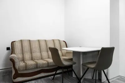 a room with a table and a couch and chairs at Apartmen-Квартира in Prague