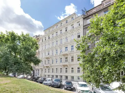 a large building with cars parked in front of it at TurnKey I Wenceslas Square Apartments in Prague