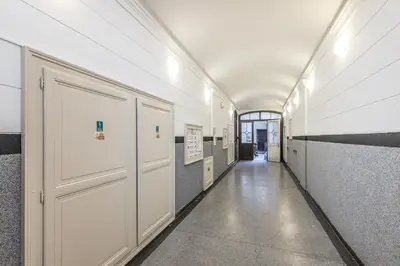 a hallway with white doors in a building at Selin Apartments in Prague