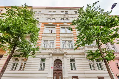 an old building with trees in front of it at Blueground Prague 2 renovated Riegrovy sady PRG-30 in Prague