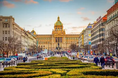 a large building with a clock tower in a city at Cozy Apartment by Wenceslas Square and Main Train Station in Prague