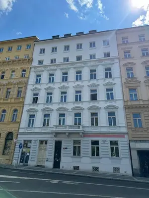 a white building on the side of a street at Modern 2BED with st Ludmila view and entire square in Prague