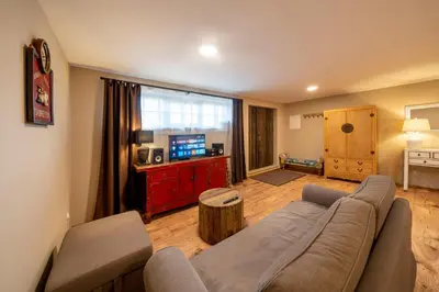 a living room with a couch and a table at Studio Flat - Sleeps 3 - Parking - Wifi in Hostivice