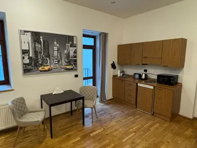 a kitchen with a table and chairs in a room at Cosy Studio with terrace near Florenc in Prague