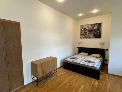 a bedroom with a bed and a painting on the wall at Studio - Sleeps 2 -Smoking on balcony - Pets -Wifi in Prague