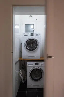 a washer and dryer in a small room at Ocean Breeze Apartment in Prague