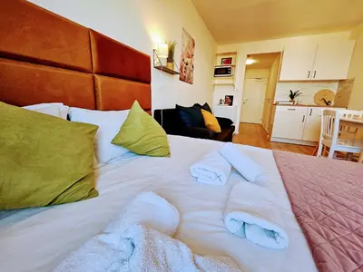 a large white bed with towels on top of it at TERRACE-VIEW PRAGUE APARTMENTS for Business & Leisure, FREE PARKING & Gym, Near Metro & Aqua Sport Centre in Prague