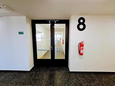 a room with a door with a fire extinguisher at TERRACE-VIEW PRAGUE APARTMENTS for Business & Leisure, FREE PARKING & Gym, Near Metro & Aqua Sport Centre in Prague
