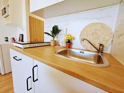 a kitchen counter with a sink in a kitchen at LIVE-INN PRAGUE SUPERIOR SUITE FOR 1-4 GUESTS, 20 Mins to center, Lift, Gym, Reception, Parking, Roof Terrace, Game & Party Room in Prague