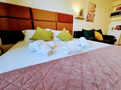 a large bed with towels on top of it at LIVE-INN PRAGUE SUPERIOR SUITE FOR 1-4 GUESTS, 20 Mins to center, Lift, Gym, Reception, Parking, Roof Terrace, Game & Party Room in Prague
