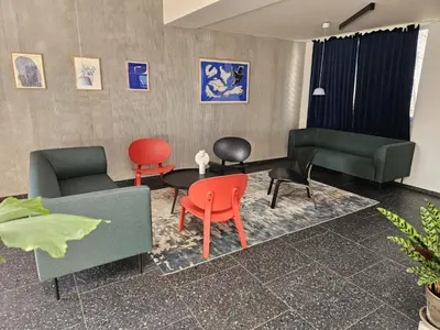a living room with colorful chairs and a table at TERRACE-VIEW 2BR PRAGUE APARTMENTS for Business & Leisure, FREE PARKING & Gym, Near Metro & Aqua Sport Centre in Prague