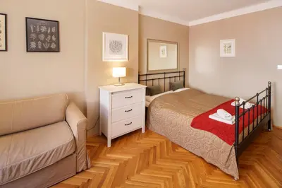 a small bedroom with a bed and a couch at 3 Bed Flat - Sleeps 12 - Wifi in Prague
