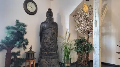 a statue in a room with a clock on the wall at Luxury Apt - View of the Center of Prague in Prague
