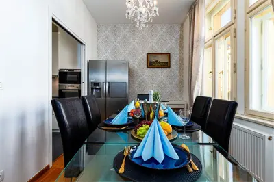 a dining room with a glass table with fruit on it at Golden Dog Suite in Prague