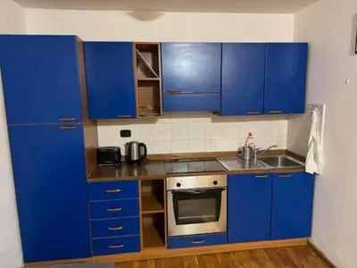 a kitchen with blue cabinets and a sink at Cool Duplex with terrace near Florenc in Prague
