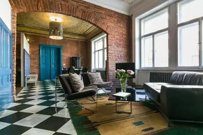 a living room with leather furniture and a brick wall at OLD TOWN - 4 Room 2 Bathroom Apartment in Prague