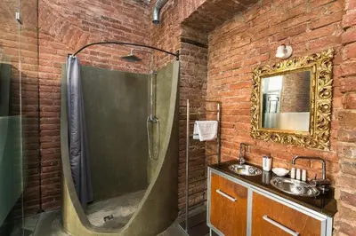 a brick bathroom with a shower and a sink at OLD TOWN - 4 Room 2 Bathroom Apartment in Prague