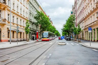 a bus driving down a city street with buildings at Blueground Prague 2 furnished Náměstí Míru PRG-44 in Prague
