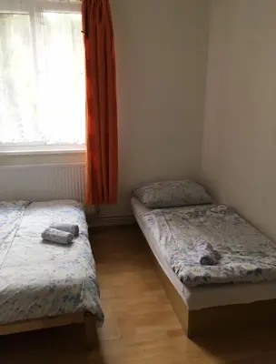 two twin beds in a room with a window at Lávka 222 in Chocerady