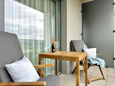 a living room with a table and a bottle of wine at REAL Living by REFA Balcony Retreat 91 in Prague