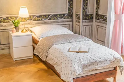 a bedroom with a bed with two books on it at Luxury Karmelitska 2B apartment in Prague
