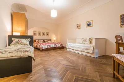 a bedroom with two beds and a wooden floor at Karmelitska 1 luxury 1 bedroom in Prague