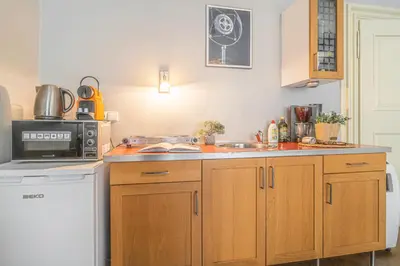 a kitchen with a sink and a microwave at Karmelitska 2 luxury 1B apartment in Prague