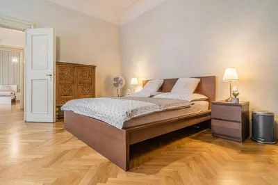 a bedroom with a large bed and a wooden floor at 2 Bed Flat - Sleeps 6 - Pets - Wifi in Prague