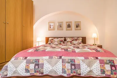 a bedroom with a bed with a quilt on it at 1 Bed Flat - Sleeps 4 - Pets - Wifi in Prague