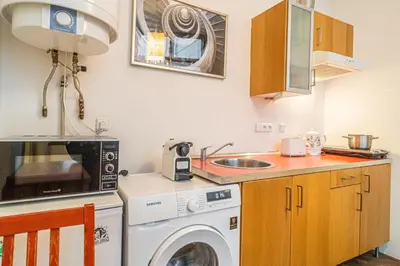 a kitchen with a washing machine and a sink at 1 Bed Flat - Sleeps 4 - Pets - Wifi in Prague
