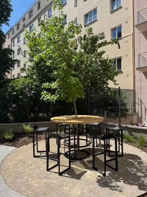 a table and chairs with a tree on top of it at Apartmán Vinohradská 160 in Prague