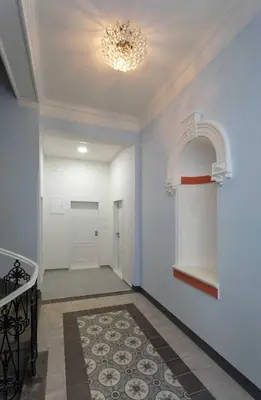 a hallway with blue walls and a chandelier at Stylish 2BR with stunning view of National Muzeum in Prague