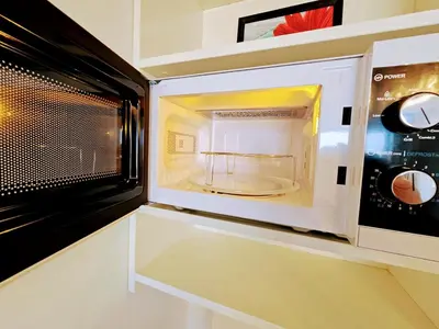 a microwave oven with its door open in a kitchen at TERRACE-VIEW PRAGUE STUDIOS for Business & Leisure, FREE PARKING, Near Metro, Gym in Prague