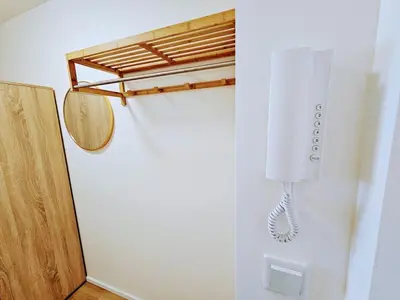 a white phone hanging on a wall next to a door at TERRACE-VIEW PRAGUE STUDIOS for Business & Leisure, FREE PARKING, Near Metro, Gym in Prague