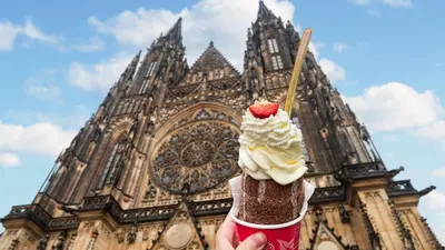 a person holding a ice cream cone in front of a building at Ubytování blízko národního muzea A1 in Prague