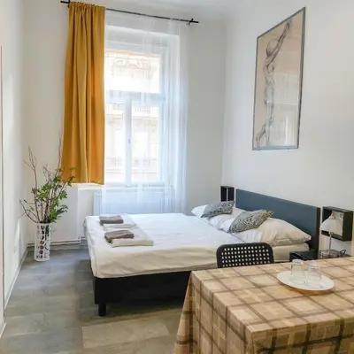 a bedroom with a bed and a table and a window at Nový pokoj u Pražského výstaviště A3 in Prague