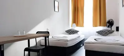 a room with two beds and a table and a desk at Zlatý pokoj v centru Prahy B1 in Prague