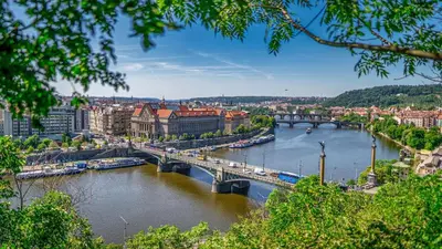 a view of a river with a bridge and buildings at Fantastický pokoj v Praze na Letné B3 in Prague