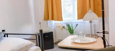 a bedroom with a table with a lamp and a bed at Single room B5 centre of Prague in Prague