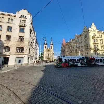 a bus is parked in a city street with buildings at Cute room D2 Prague 7 in Prague