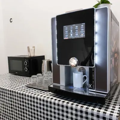 a coffeemaker on a table with a black and white checkered table at Friends on the Road D4 Prague in Prague
